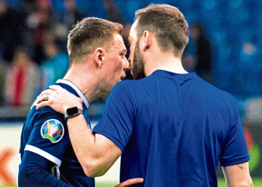 Scotland captain Callum McGregor (L) exchanges words with assistant manager, James McFadden at full time