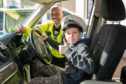 Ben Richards, 10, inside a police car at the Moray Blue Lights Festival.