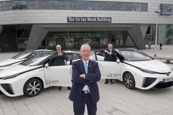 27/03/19
L-R Bill Somerville- RGU Director of Estates and Properties Services,Councillor Philip Bell, Aberdeen City Council’s operational delivery vice convener, Co-wheels Car Club Scotland Manager Tony Archer

Aberdeen City Council’s ambitious hydrogen programme is set to reach an even wider audience with the addition of the first two cars available for public use.The Toyota Mirai models will join the Co-wheels Car Club fleet in the city and will be available for club members to hire through the online booking system.The Mirai, winner of the World Car Awards’ green car of the year award, uses hydrogen fuel cell technology to enable long-distance emission free motoring – with a range of about 300 miles.The cars have received EU Interreg North Sea Region funding through the Hydrogen Transport Economy (HyTrEc)2 Project in which Aberdeen City Council is a partner. This is part of the Aberdeen City Region Hydrogen Strategy and Action Plan 2015-2025 to develop a hydrogen economy in the region.The distinctive cars are already becoming a familiar sight on the Aberdeen roads, with the council already using the Mirai as part of its fleet.The two new additions to the public Co-wheels hire will be stationed at Gallowgate Car Park and East Craibstone Street from 1 April.Aberdeen has two hydrogen refuelling stations, at Kittybrewster and Cove, to support the growing fleet of cars, buses, and commercial vehicles operating in the city as part of the innovative programme.