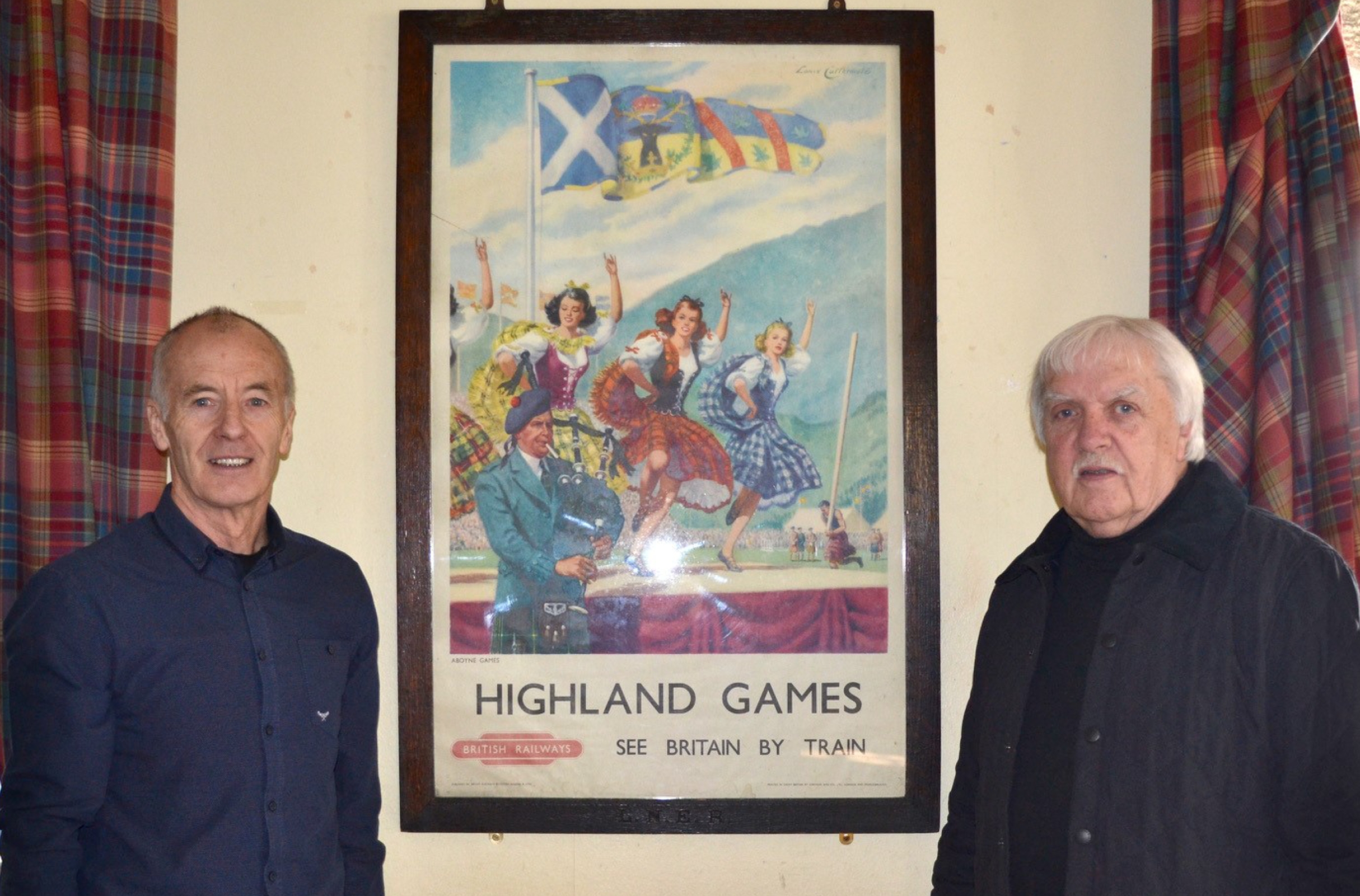 Alistair Grant (left) chairman of Aboyne Highland Games and committee member Wilson Forbes with the poster