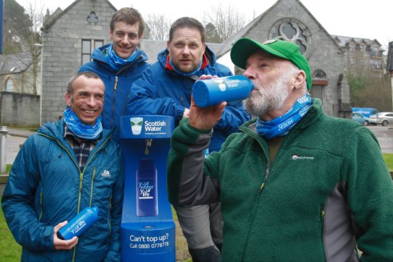 Members of Lochaber Mountain Team joined Cameron McNeish as he drew the first bottle of water from the Fort William Top up Tap.