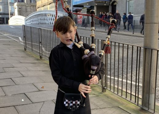 Josh Bruce, 10, performing in Aberdeen city centre.