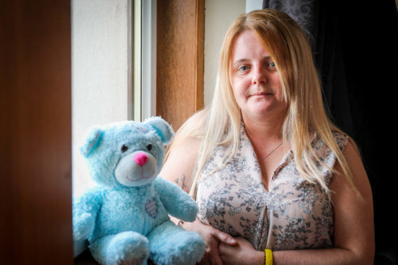Laura Gallazzi with Steven's teddy bear, which now contains his ashes.