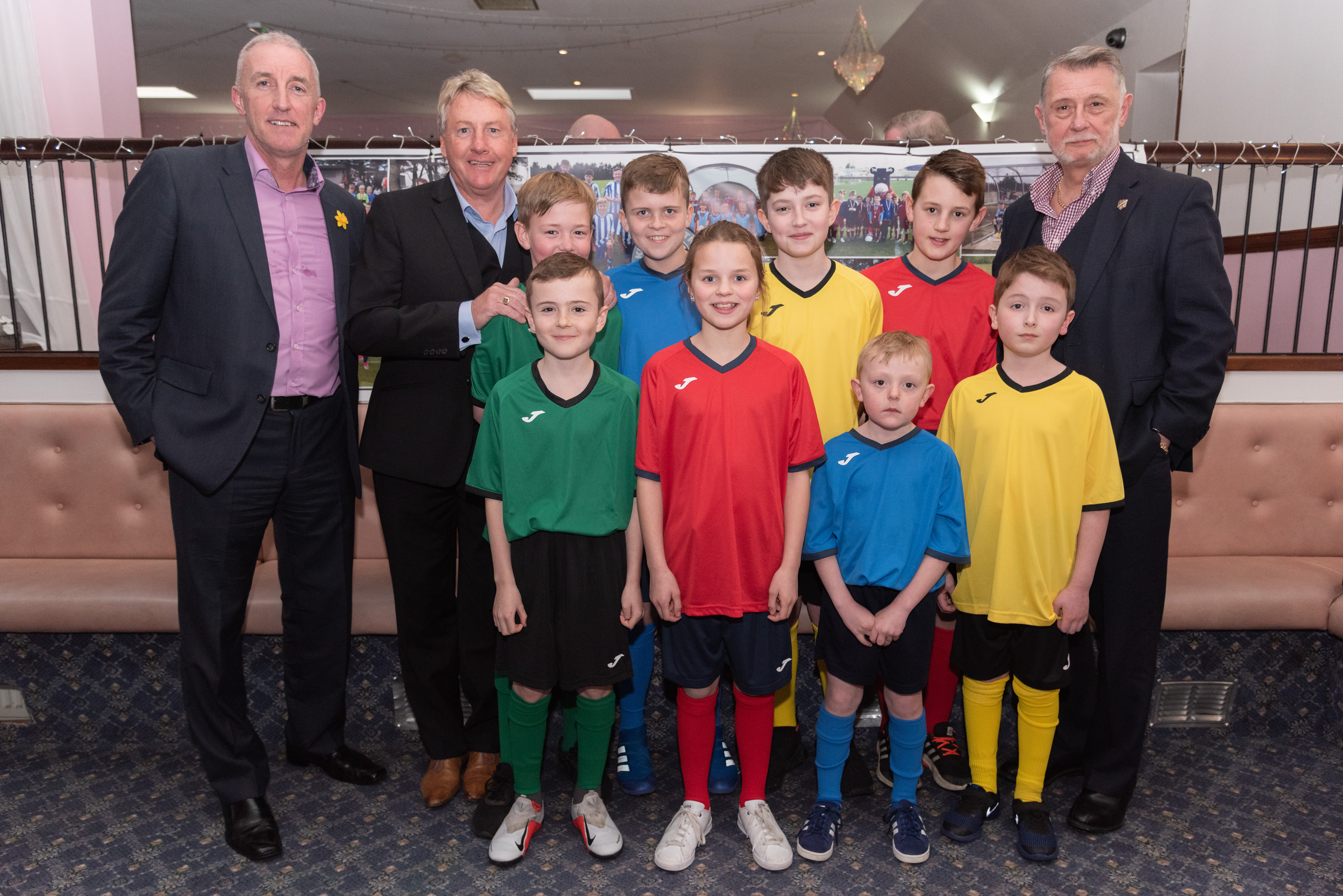 The money used will help the group buy new equipment and football strips. Pictured, with guest speakers Frank McAvennie and Donald Findlay: Lucy Mark, Ben Fettes, Lewie Mckenzie, Ryan Garden, Logan Mckenzie, Sonny Dalgarno, Jake Taylor, Finn Davidson.