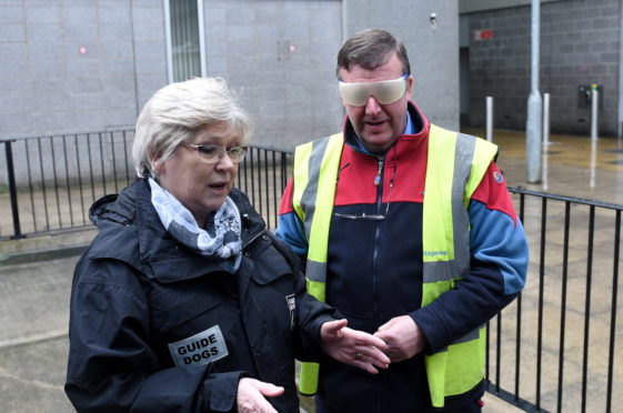 Pamela Munro, engagement officer for Guide Dogs Scotland, and Keith Boyd, Stagecoach bus driver, take part in training sessions at Aberdeen Bus Station.