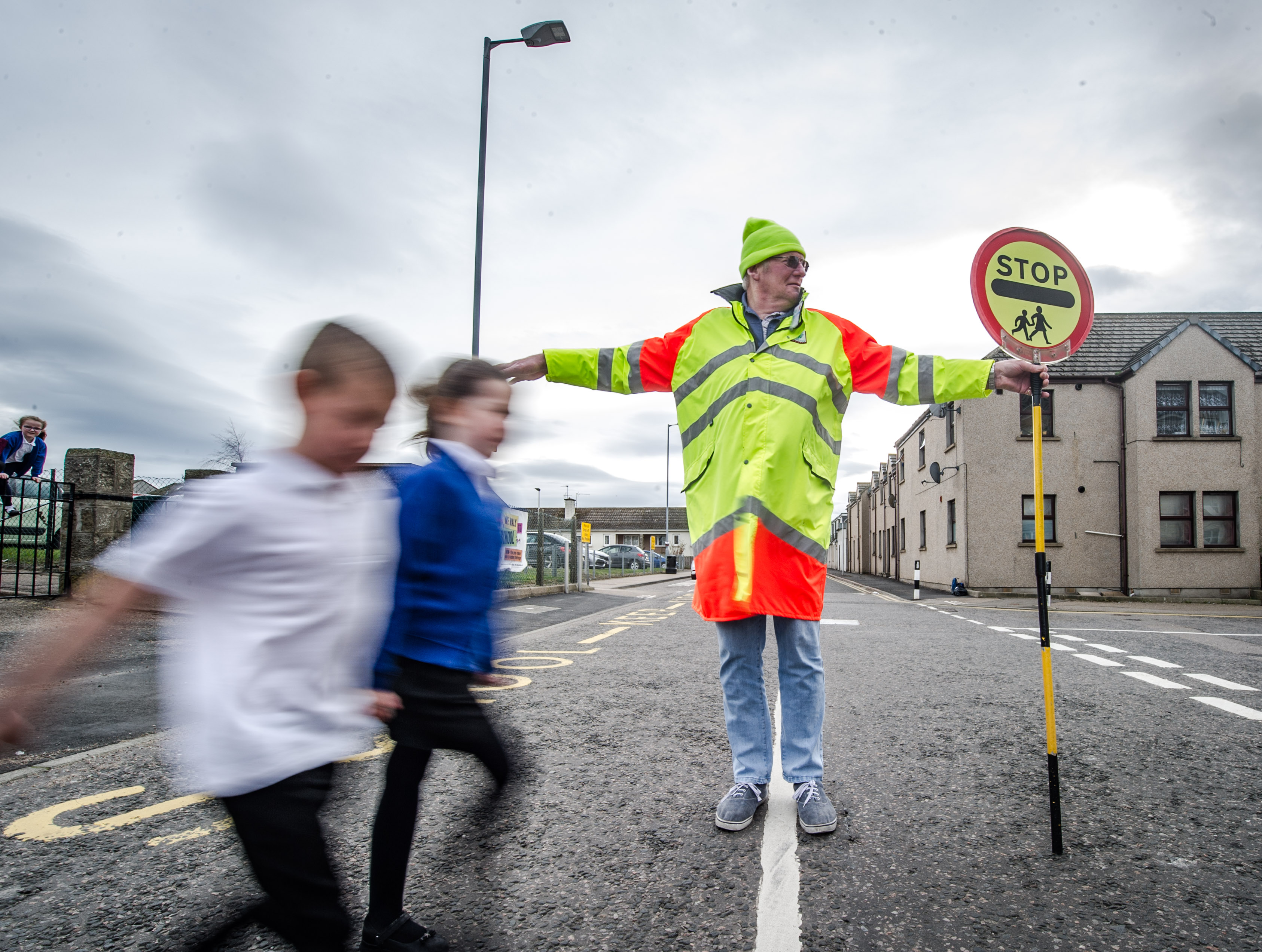 Picture by JASON HEDGES    
Stock Images; lollipop man; lollipop lady, school crossing, stop sign; children crossing.

A lollipop person proviodes safe crossings at a road next to New Elgin Primary School in Moray fro children to cross.

Pictures Jason Hedges