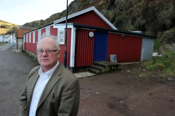 Pennan Community Councillor Bill Pitt outside the village hall.