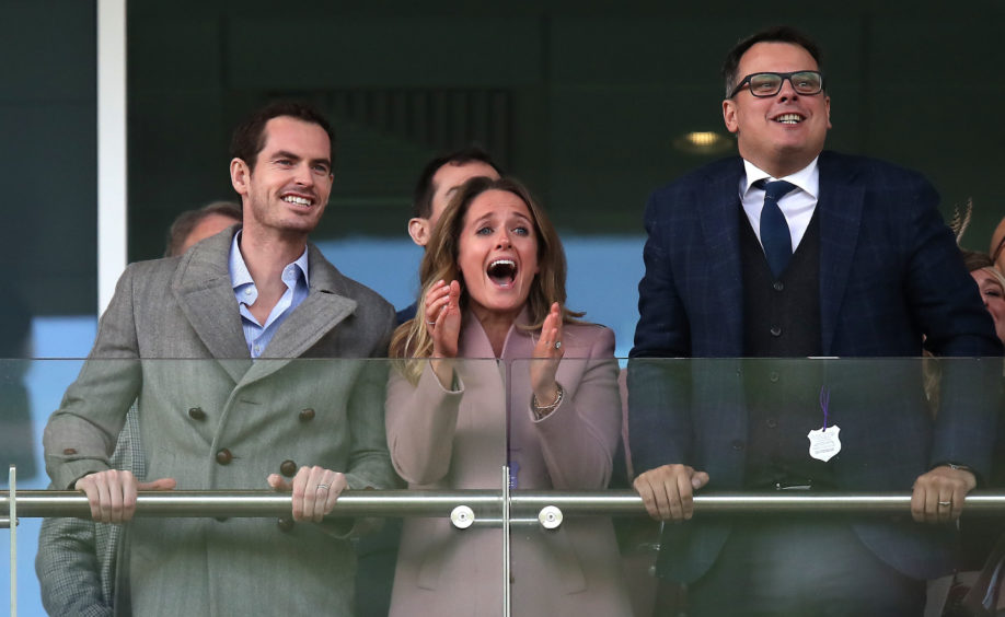 Andy Murray and Kim Murray react as they watch the action from the stands.