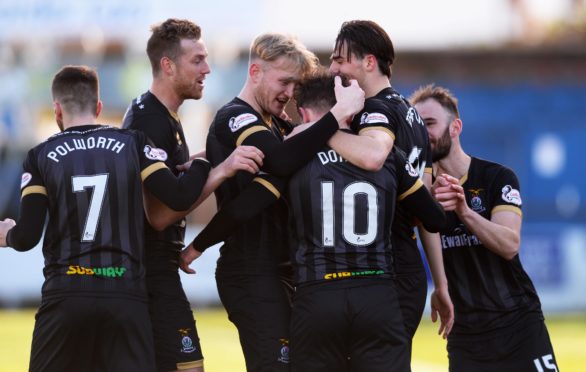 Aaron Doran celebrates with teammates Charlie Trafford and Liam Polworth after scoring to make it 1-0