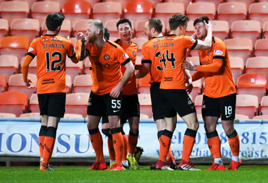 Calum Butcher (R) is congratulated by his teammates after firing Dundee United ahead.