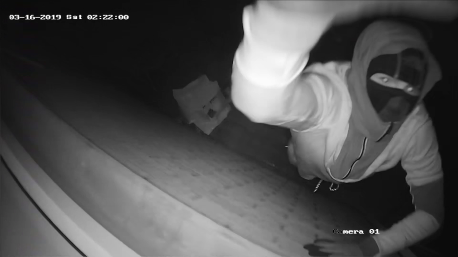 One of the raiders caught in frame smashing the CCTV camera.
