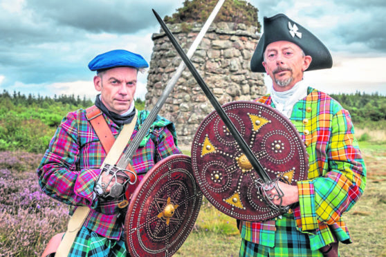 Men dressed as Jacobite warriors at Culloden.
