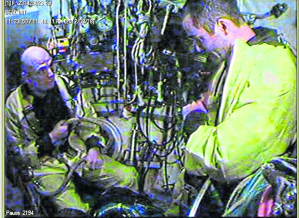 (L-R) Diver 2, Chris Lemons and Diver 1, Dave Yuasa in the bell,  after recovery.