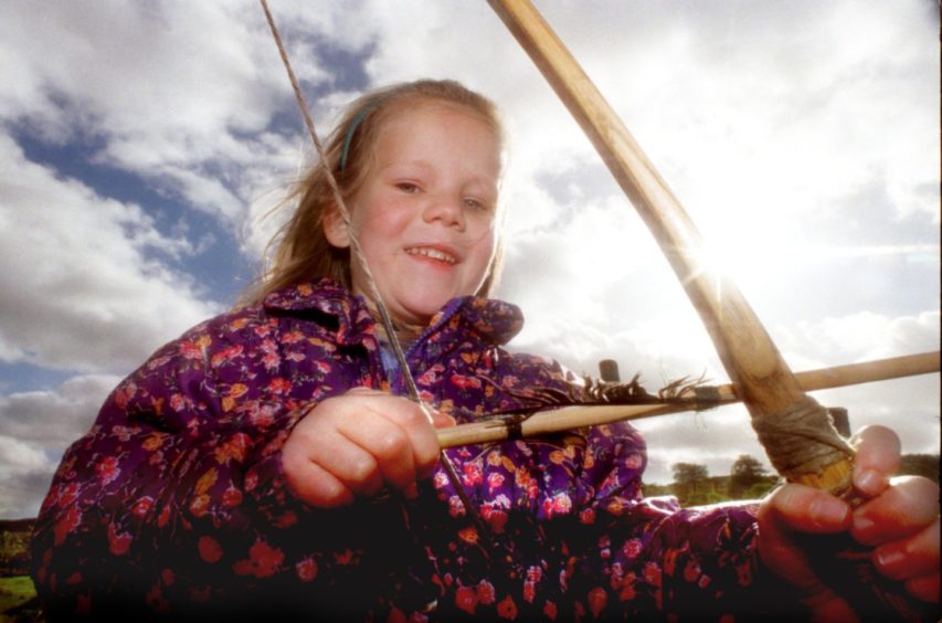 Kirsty Coombs 6 from Banchory takes a lesson in Longbow at Archaeolink.