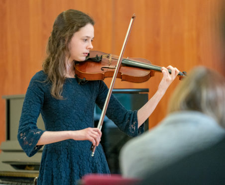 This is from the 48th Annual Festival of Scots Fiddle Music takes place in Elgin, where fiddle players across the north-east come to compete in the competition. It was held in Williamson Hall, Duff Avenue, Elgin, Moray, Scotland on Sauturday 27 April 2019. PICTURE CONTENT:- Charlotte Slater from Ellon plays to win the 13-16yrs, March, Strathspey and Reel.