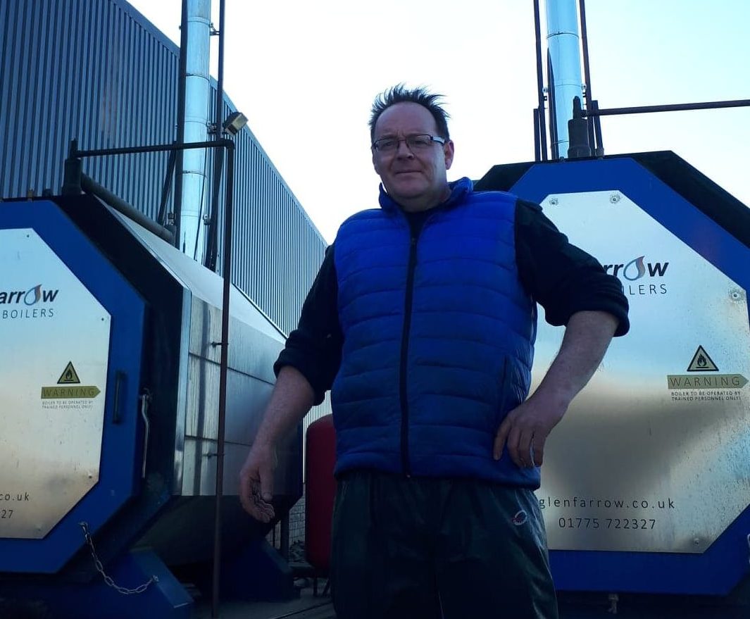Neil Benzie with the two biomass boilers, the one on the right which has been off since January and the one on the left which was still on at the time of the picture on April 29