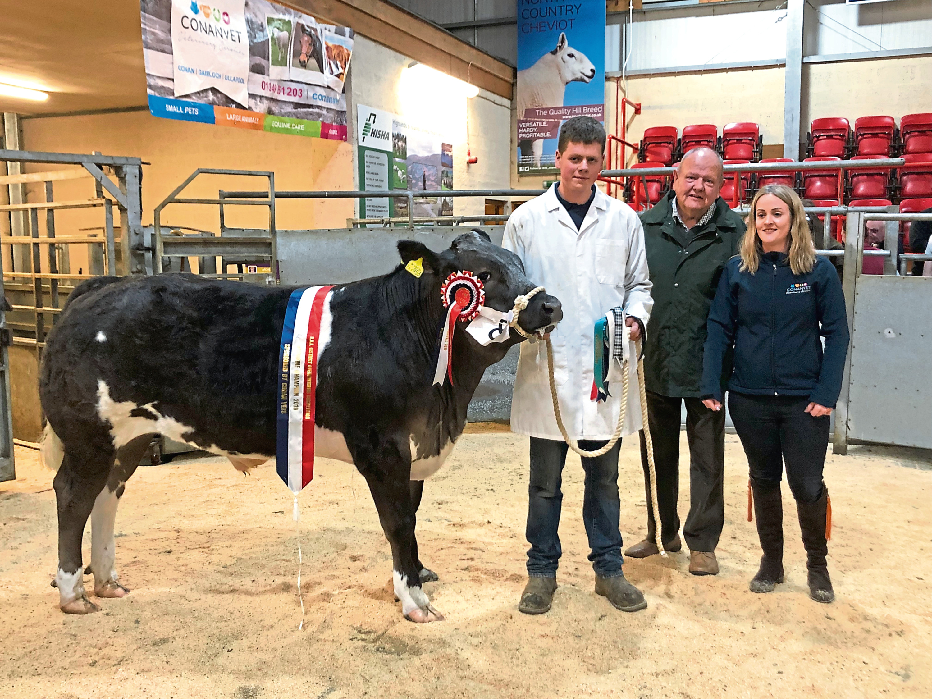 David Dingwall with his overall champion animal which sold for £1,200, pictured with the judge Jock McCallum, Mountrich, Dingwall, and Mary-Jo Grant of sponsors, Conanvet.