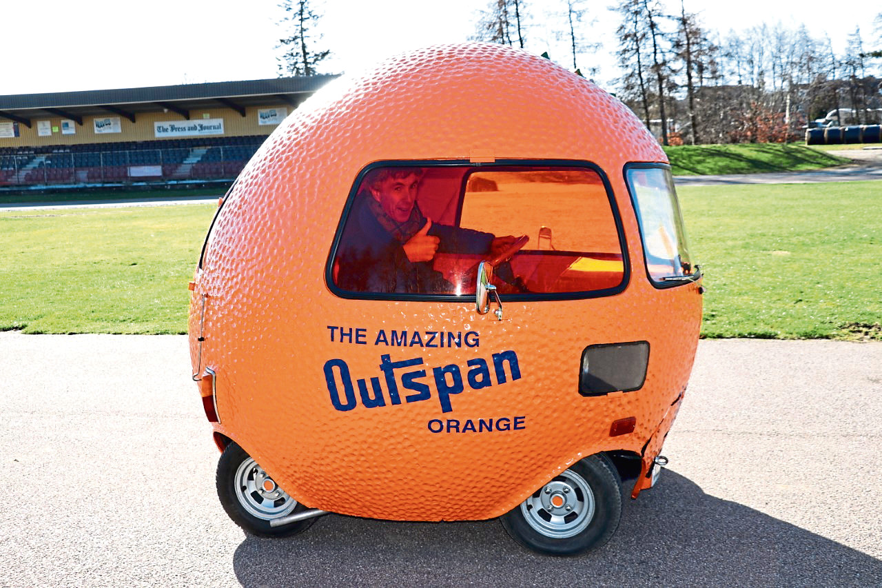 Andrew tries out the Outspan orange car at Grampian Motor Museum