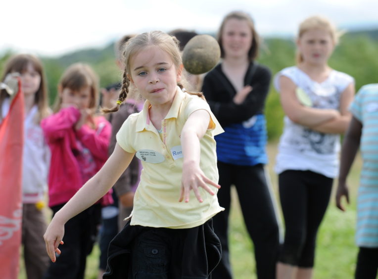Taking part in the annual mini highland games at Archaeolink, Oyne is Katie McDougall from the Westhill Kids holiday club. . 
Picture by Jim Irvine