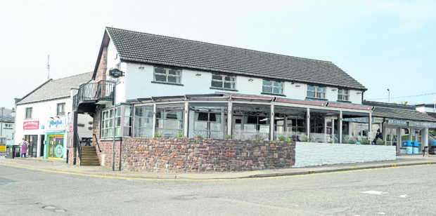 The partially white painted wall outside The Seaforth in Ullapool which caused a planning row.