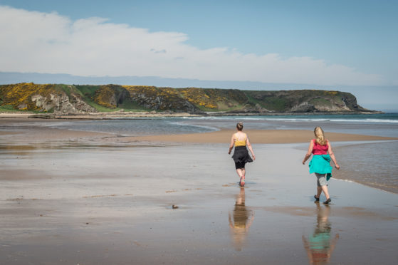 Walkers on the beach at Cullen.