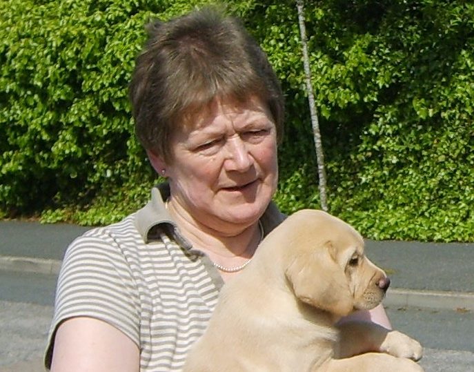 Christine Neish with one of the guide dog puppies she helped prepare for a life of helping others.