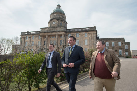 Moray MP Douglas Ross, Shadow Health Secretary Miles Briggs and Highlands and Islands MSP Jamie Halcro Johnston outside Dr Gray's Hospital.