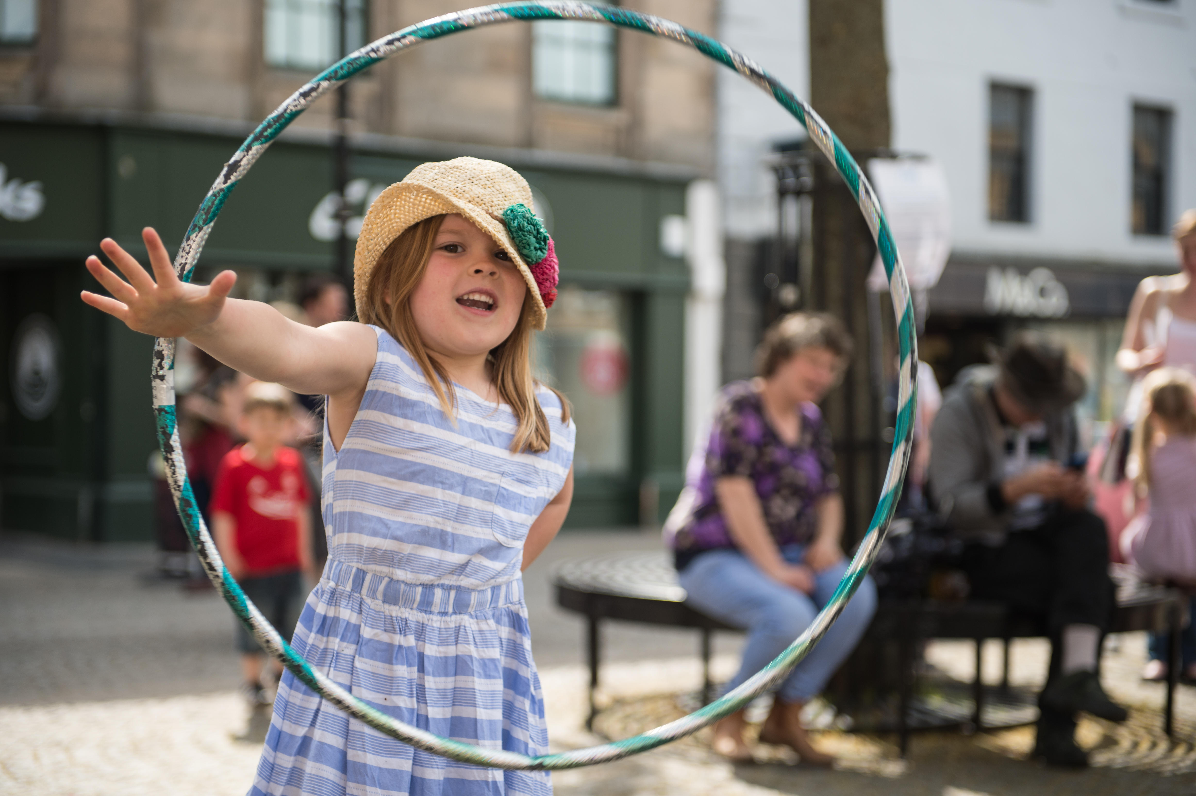 Ottilie Scott hula hooping as part of Elgin business improvement district's Easter day.