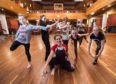 Dance instructor Crystal Zillwood surrounded by Dance North Scotland pupils.
