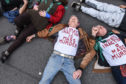 NEW YORK, NY - APRIL 17: People participate in a die-in direct action with a group protest organization called Extinction Rebellion on April 17, 2019 in New York City. The activists are demanding governments declare a climate emergency to combat pollution. (Photo by Stephanie Keith/Getty Images)