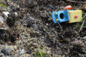 NORTH QUEENSFERRY, SCOTLAND - AUGUST 28: A child's plastic toy lies among some of the thousands of plastic pellets along the high water mark on the Firth of Forth, as a new map is published by a charity group showing the extent of marine litter and pollution around Scotland's coastline, on August 28, 2018 in North Queensferry, Scotland. The charity Sky Watch Civil Air Patrol have been surveying some of Scotland's coastline by air, using aerial photography to pinpoint pollution hotspots, and in collaboration with Moray Firth Partnership and the Marine Conservation Society have produced an interactive online map which it is hoped will help understand sources of pollution and facilitate clean-up efforts. (Photo by Ken Jack - Corbis/Corbis via Getty Images)
