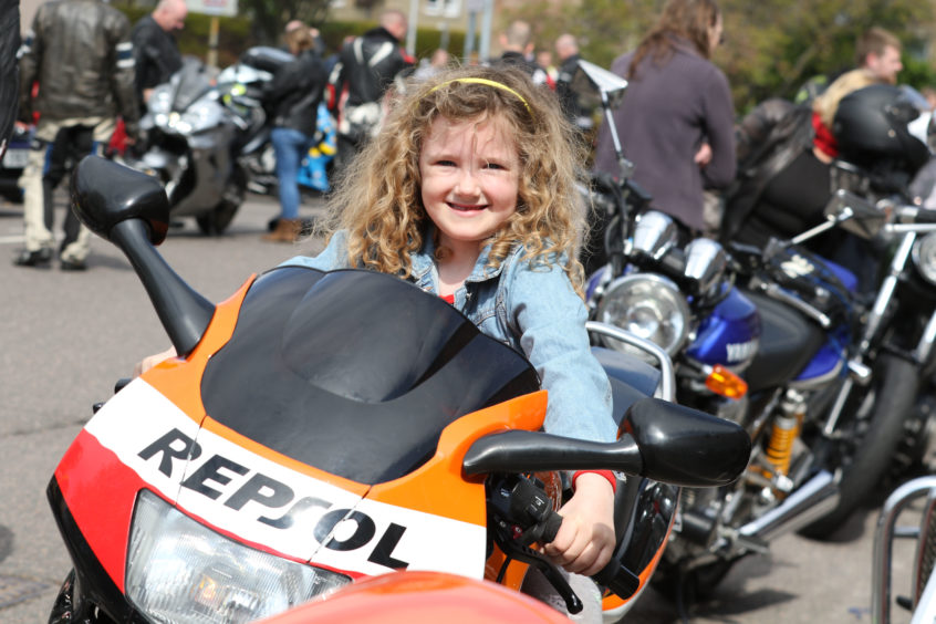 Blythe Gajda (6) from Westhill, who describes herself as "bike daft", having a go on a Honda CBR 600. Credit: Andrew Smith
