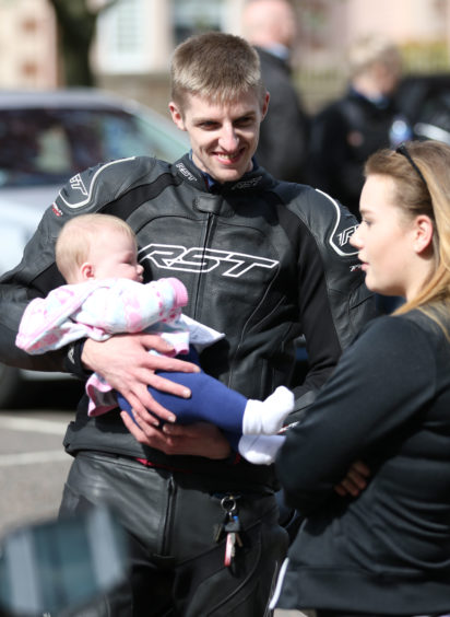 One of the riders, Steven Webster, with his friend Rachel Dunn's 5-month-old daughter Maisie. Credit: Andrew Smith