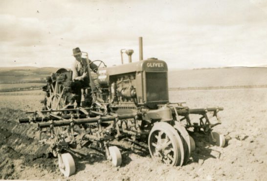 Working a field with an Oliver 80 Row Crop tractor