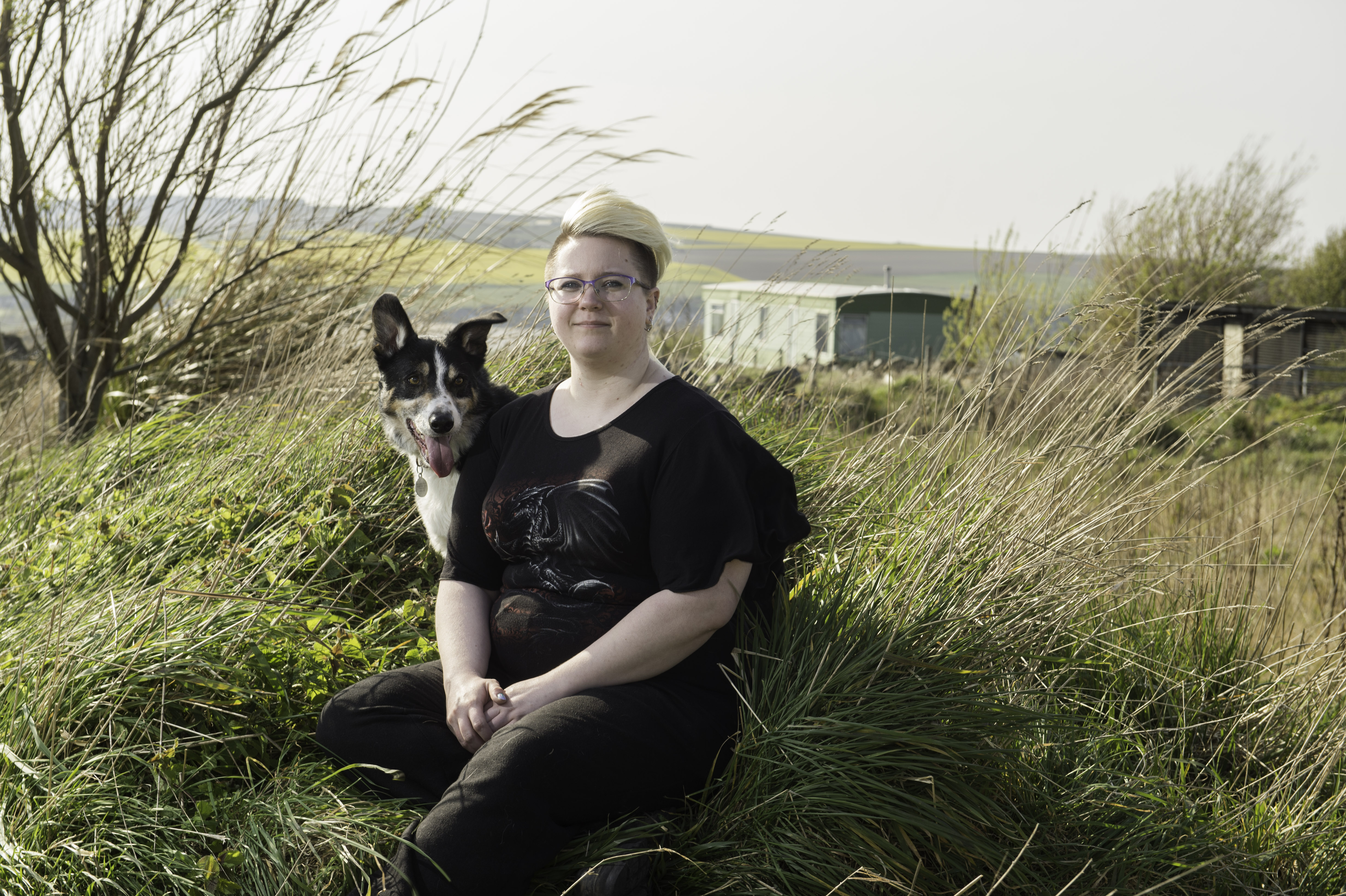 Sophie Perrett outside her home and farm in Portsoy with Rusty the dog.