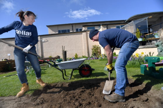 Julie Jamieson and Phil Argo of Kellas Midstream at work revamping the garden along with the team.    
Picture by Kami Thomson