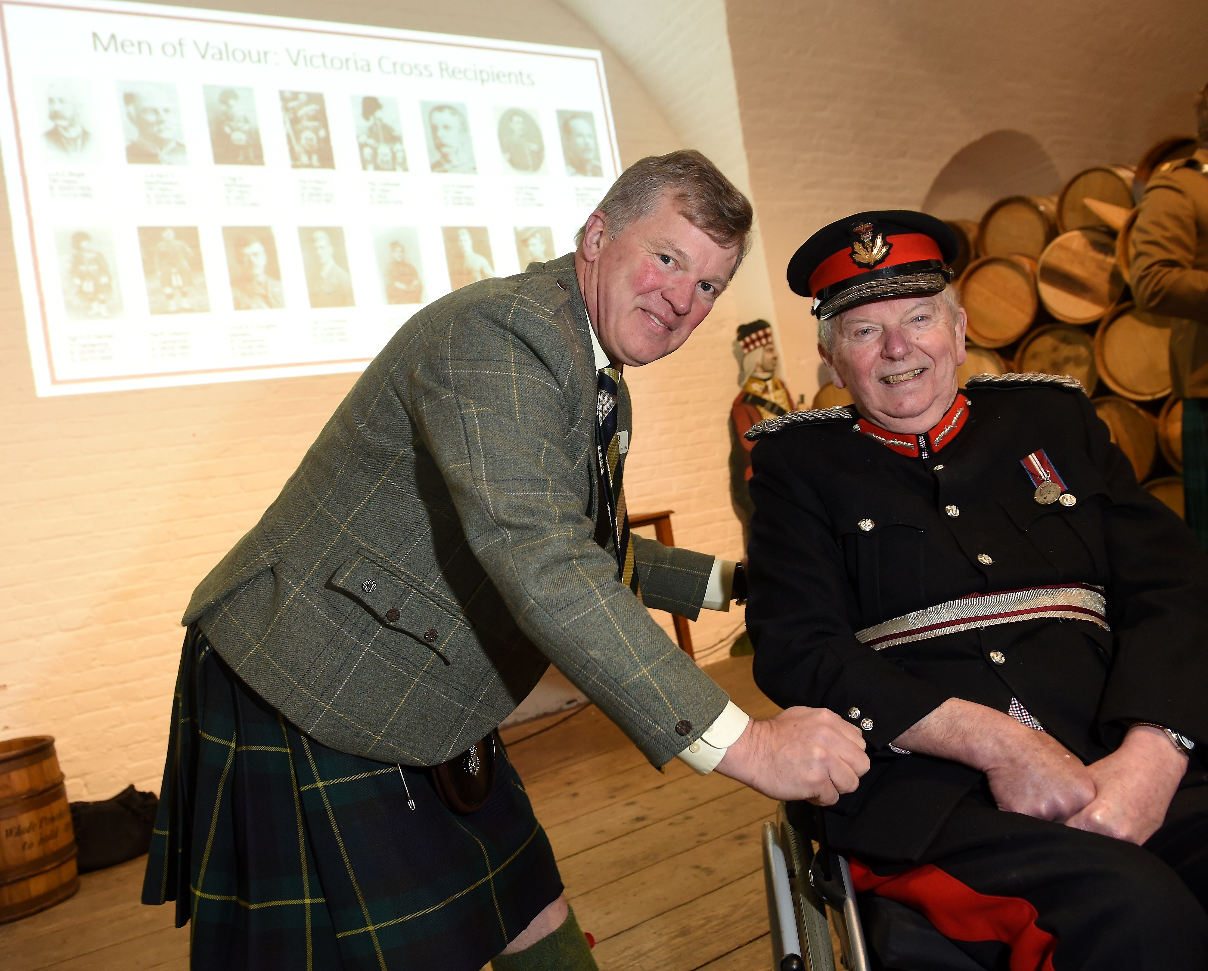 Sixteen Victoria Crosses were unveiled yesterday in the grand Magazine of Fort George which are to go on display the Highlanders Regimental Museum at Fort George. Maurice Gibson (left) Chairman of The Highlanders Museum Board with Donald Cameron of Locheil following the unveiling of the medals. Picture by Sandy McCook