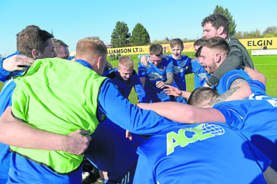 The Cove players and management celebrate winning the title after the final whistle against Forres Mechanics. Picture by Sandy McCook.