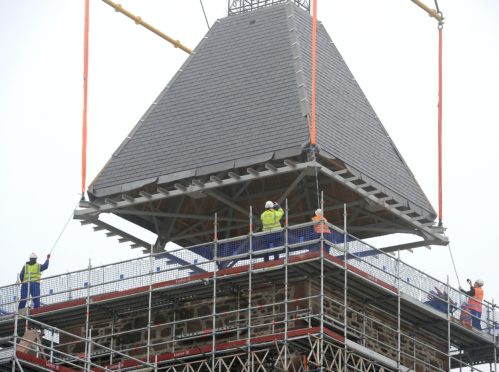 The prefabricated twenty three ton roof of one of the towers of the former Craig Dunain Hospital was lifted in to place this morning after being cancelled on Wednesday due to high winds. Picture by Sandy McCook