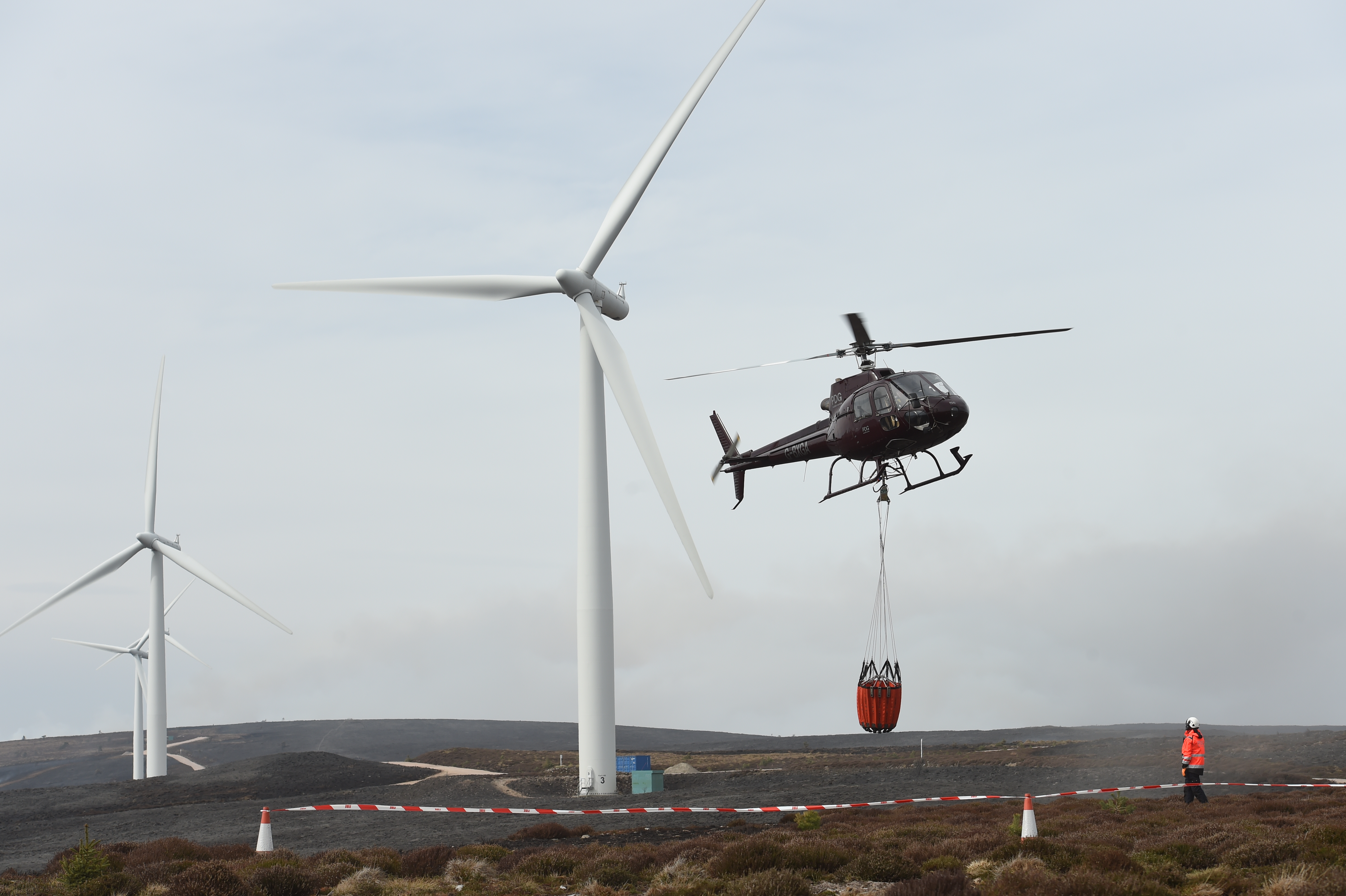 A helicopter sets out to pour water over wildfires in Moray