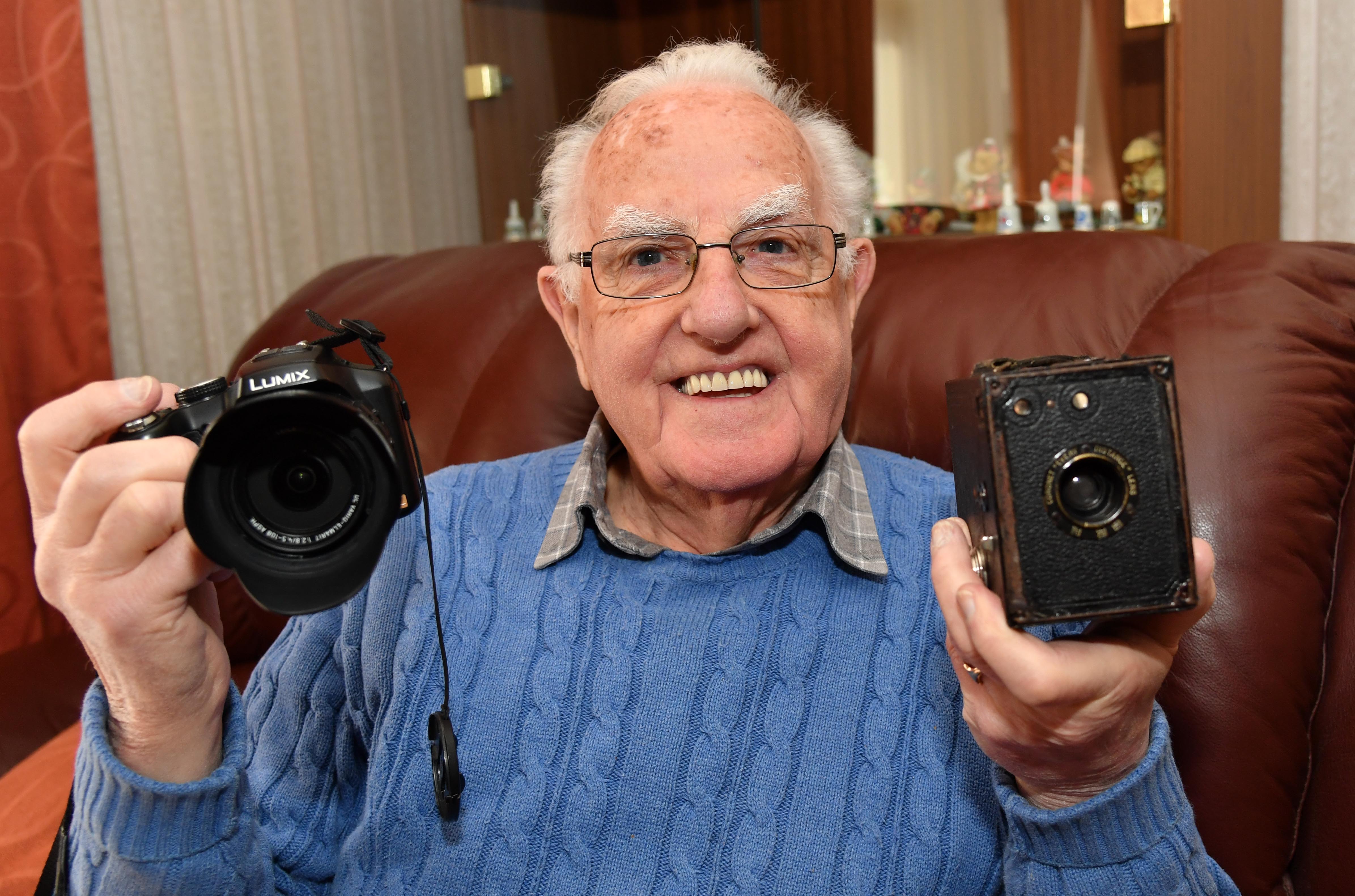 Fraserburgh Photographic Society's former president Andrew West with the Coronet Box Camera he took his first picture with in 1945 and his latest  lightweight digital camera