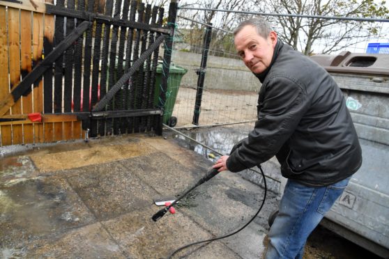 Rockfish owner James Pirie cleaning up the damage caused by vandals