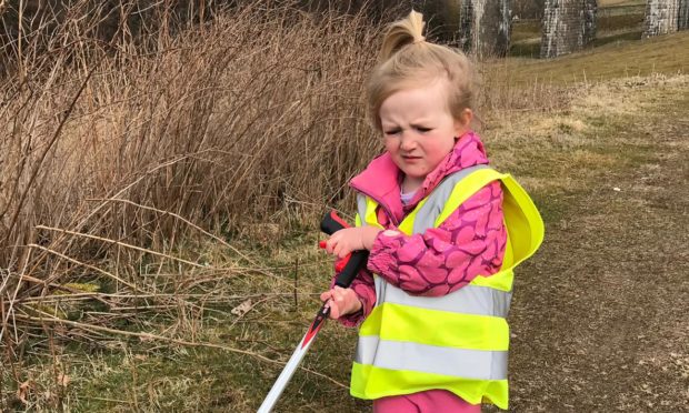 A young litter picker cleaning up at Tomatin.