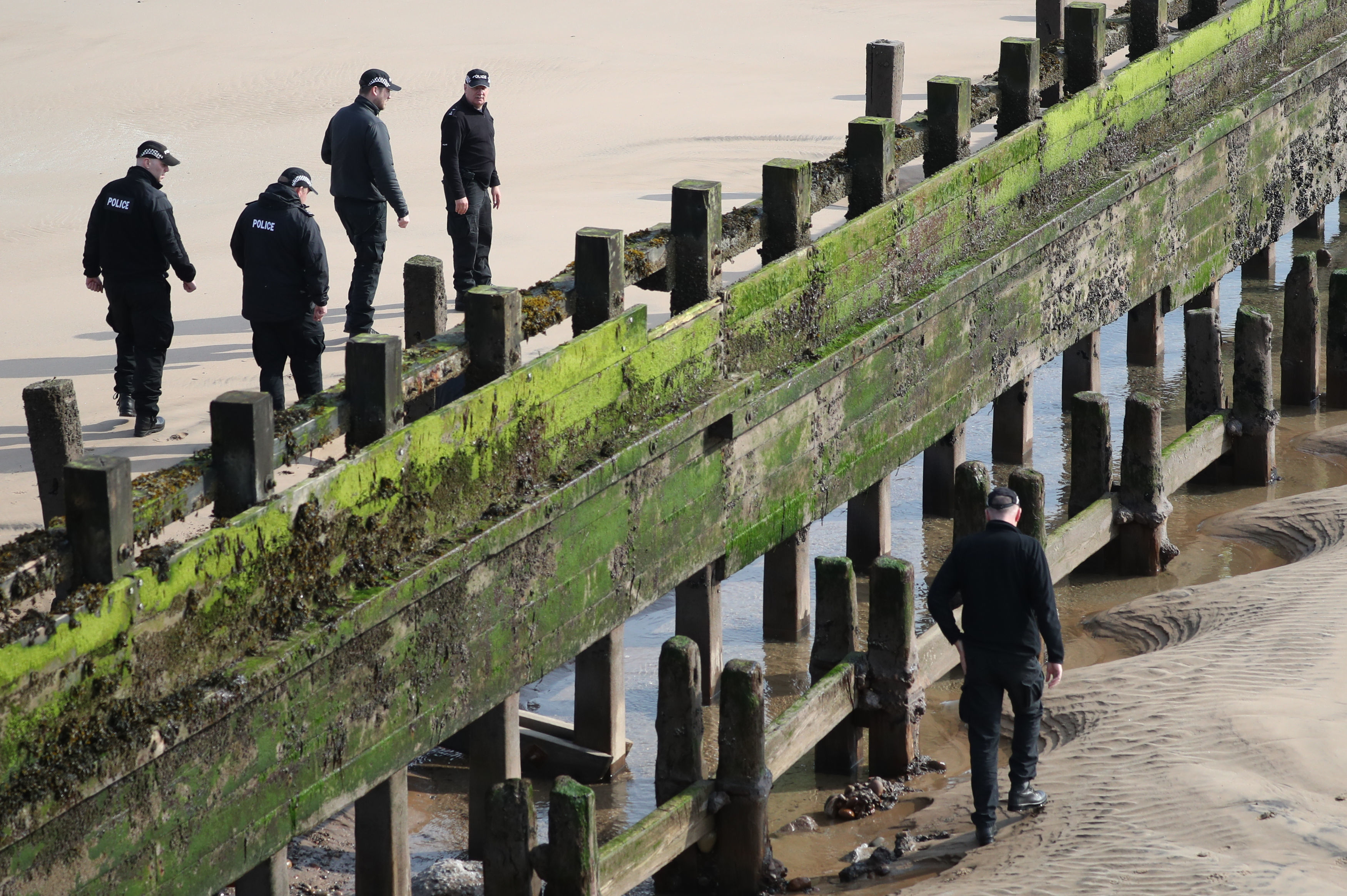 Police search beside one of the groynes at Aberdeen beach