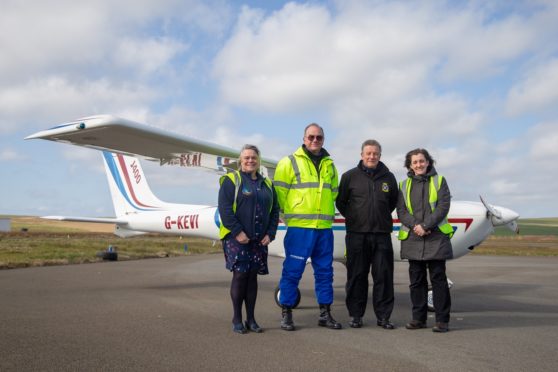 Helen Houston, chair of the Moray Firth Partnership, volunteer Pilots Dave Brown, Paul Horth and Marie Stanton, Highland Park, launch the SCRAPbook coastal mapping in Orkney.