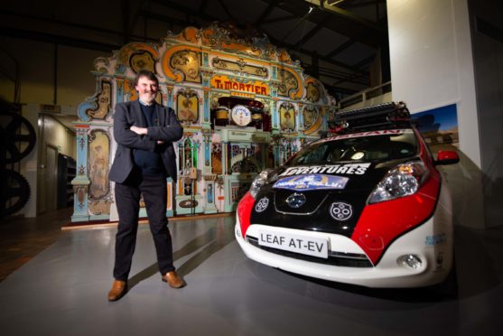 Mike Ward with the new exhibitions. He is pictured with the new Nissan Leaf rally car.