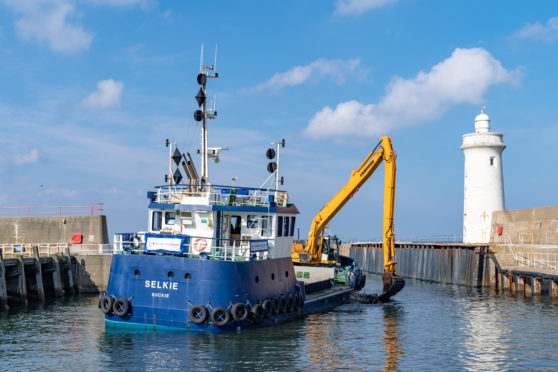 The Selkie dredging at Buckie Harbour.