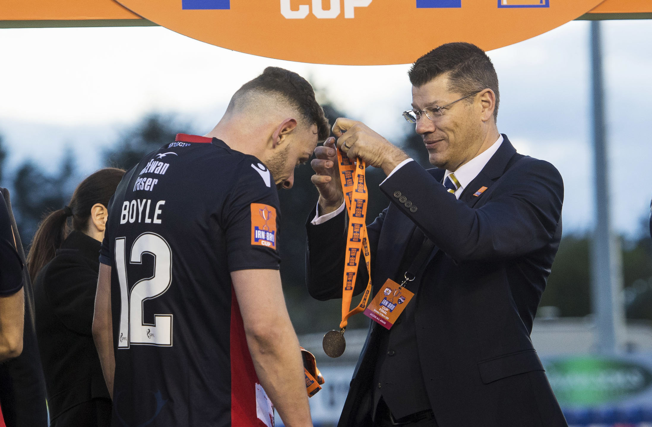 Andy Boyle receives his IRN-BRU Cup medal from SPFL chief executive Neil Doncaster.