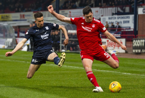 Aberdeen's Scott McKenna (R) in action with Dundee's Cameron Kerr.