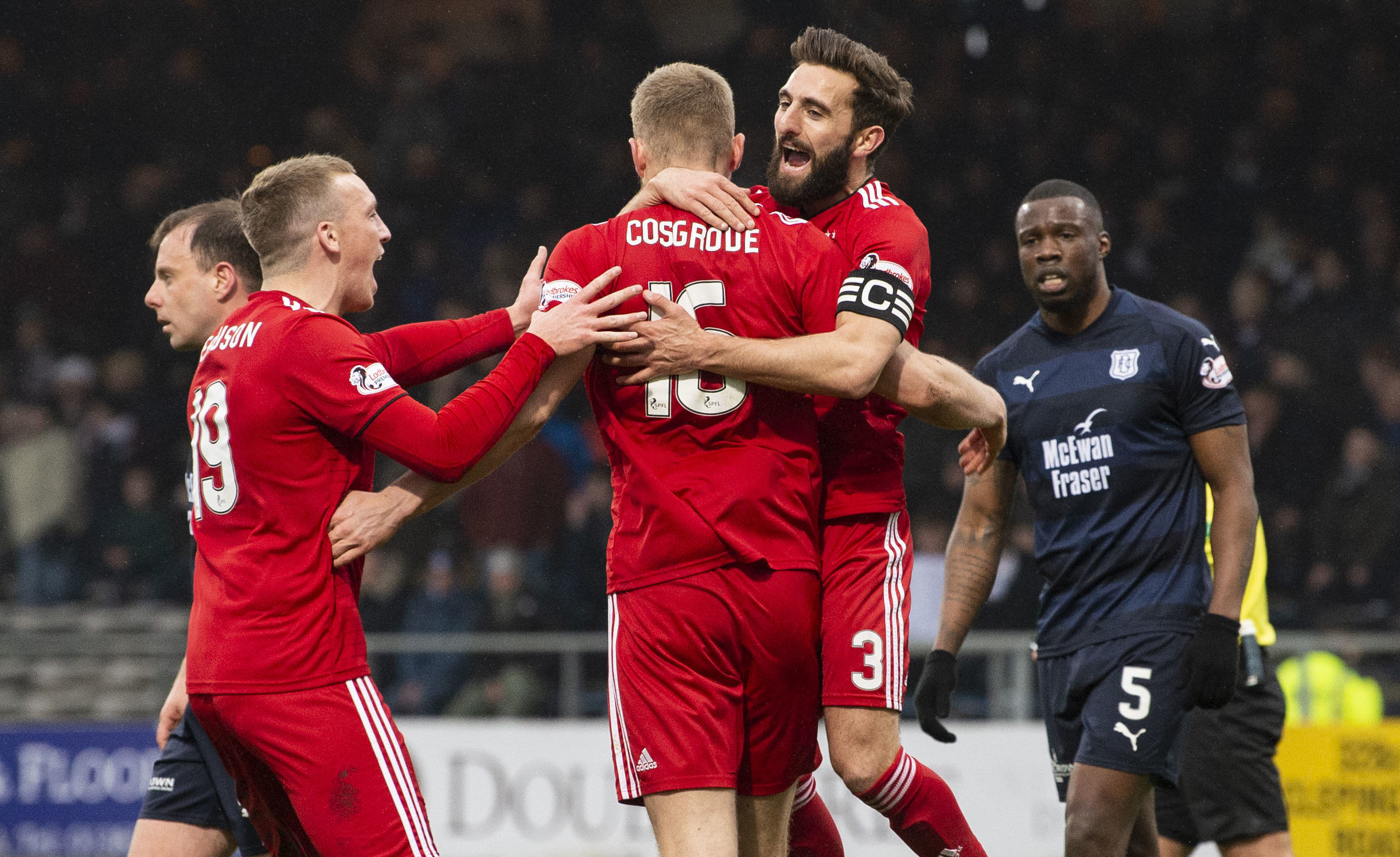 Aberdeen's Sam Cosgrove celebrates putting his side 1-0 up with Graeme Shinnie and Lewis Ferguson (L).